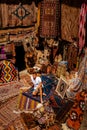 Young man tourist at an old traditional Turkish carpet shop in cave house Cappadocia, Turkey Kapadokya Royalty Free Stock Photo