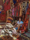 Young man tourist at an old traditional Turkish carpet shop in cave house Cappadocia, Turkey Kapadokya Royalty Free Stock Photo