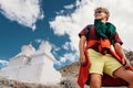 Young man tourist portrait with buddhist holy stupas on background