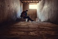 Young man tourist sits with laptop in old tibetan palace