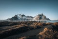 Young man tourist standing at beach during sunset runrise and gorgeous reflection of Vestrahorn mountain on Stokksnes Royalty Free Stock Photo