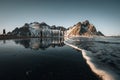 Young man tourist standing at beach during sunset runrise and gorgeous reflection of Vestrahorn mountain on Stokksnes Royalty Free Stock Photo