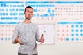 Young man is traffic rules instructor on blurred background of the training room with traffic signs Royalty Free Stock Photo