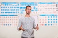 Young man is traffic rules instructor on blurred background of the training room with traffic signs Royalty Free Stock Photo