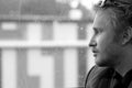 Young man on train trip looking out window daydreaming Royalty Free Stock Photo