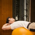 Young man training abs on fitness ball Royalty Free Stock Photo