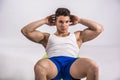 Young man training abs on fitness ball Royalty Free Stock Photo