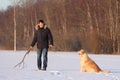 A young man training his dog golden retriever. Royalty Free Stock Photo