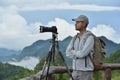 Young man travel photographer taking nature photo of mountain landscape Thailand Royalty Free Stock Photo