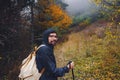 young man traveler in autumn misty nature Royalty Free Stock Photo