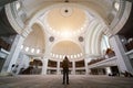 Young man traveler with backpack walking to Wilayah Persekutuan mosque in Kuala Lumpur, Malaysia