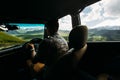 Young Man Traveler Driving A Car In The Mountains In Summer, Rear View From The Car Royalty Free Stock Photo