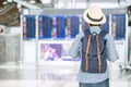 Young man traveler with hipster backpack checking flight time, Asian passenger with hat looking to information board in Royalty Free Stock Photo