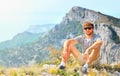 Young Man Traveler relaxing with Mountains on background