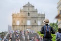 Young man traveling backpacker with hat, Asian hipster traveler looking to Ruins of St. Paul`s, Historic Centre of Macau, a UNESC Royalty Free Stock Photo