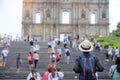 Young man traveling backpacker with hat, Asian hipster traveler looking to Ruins of St. Paul`s, Historic Centre of Macau, a UNESC Royalty Free Stock Photo