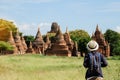 Young man traveling backpacker with hat, Asian traveler looking Beautiful ancient temples and pagoda, landmark and popular for Royalty Free Stock Photo