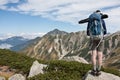 Young man traveling photographer with backpack and tripod stand