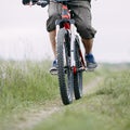Man traveling riding bicycle along a country road. Royalty Free Stock Photo