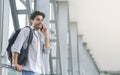 Young man traveller talking on mobile phone in airport Royalty Free Stock Photo