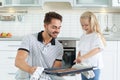 Young man treating his daughter with homemade oven baked baked cookies