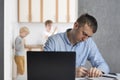 Young man tries to focus on work while the children make noise. Work at home, freelance, distant work