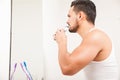 Young man trimming his beard in the bathroom Royalty Free Stock Photo