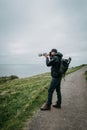 Young man trourist traveler hiking. Tjornuvik beautiful town in the Faroe Islands, sit on the north coast of Streymoy