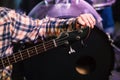 Young man tuning electric guitar. Close up