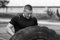 Young Man Turning Tires Outdoor