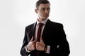 Young man in a tuxedo with tie. Is adjusting his jacket Royalty Free Stock Photo