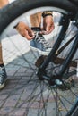 Young man tying his shoelaces before starting daily bike trips, closeup. Lifestyle Activity Footwear Concept