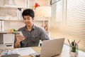 Young man typing chat or message on mobile phone with smiling face Royalty Free Stock Photo