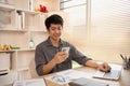 Young man typing chat or message on mobile phone with smiling face Royalty Free Stock Photo