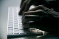 Young man typing in a computer keyboard Royalty Free Stock Photo