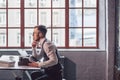 Young man typing a screenplay indoors Royalty Free Stock Photo