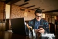 A young man typing a text on mobile modern smartphone. Hipster holding a modern phone and writing a phone message Royalty Free Stock Photo