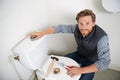 young man unclogging toilet at clients home