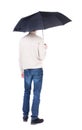 Young man under an umbrella.