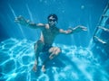 Young man under the water of a swimming pool Royalty Free Stock Photo