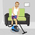 Young man in underwear cleaning carpet with vacuum cleaner at home