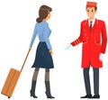 Young man in uniform working as bellboy in hotel. Doorman helps female visitor with luggage