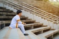 Man university graduates in graduation gown sitting on stairs Royalty Free Stock Photo