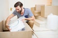 Young man unpacking carton boxes Royalty Free Stock Photo