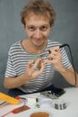 Young man use iron soldering electric parts