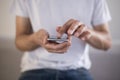 Young man using touchscreen smartphone. Concept for using technology, shopping online, using mobile apps, texting, phone addiction Royalty Free Stock Photo