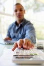 Young Man On Using Calculator At Home Royalty Free Stock Photo