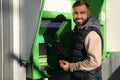 Young man using cash machine for money withdrawal outdoors Royalty Free Stock Photo