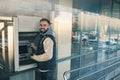 Young man using cash machine for money withdrawal outdoors Royalty Free Stock Photo