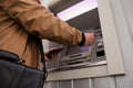 Young man using cash machine for money withdrawal outdoors, closeup Royalty Free Stock Photo